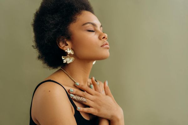 Woman meditating with calm breathing and peaceful expression.